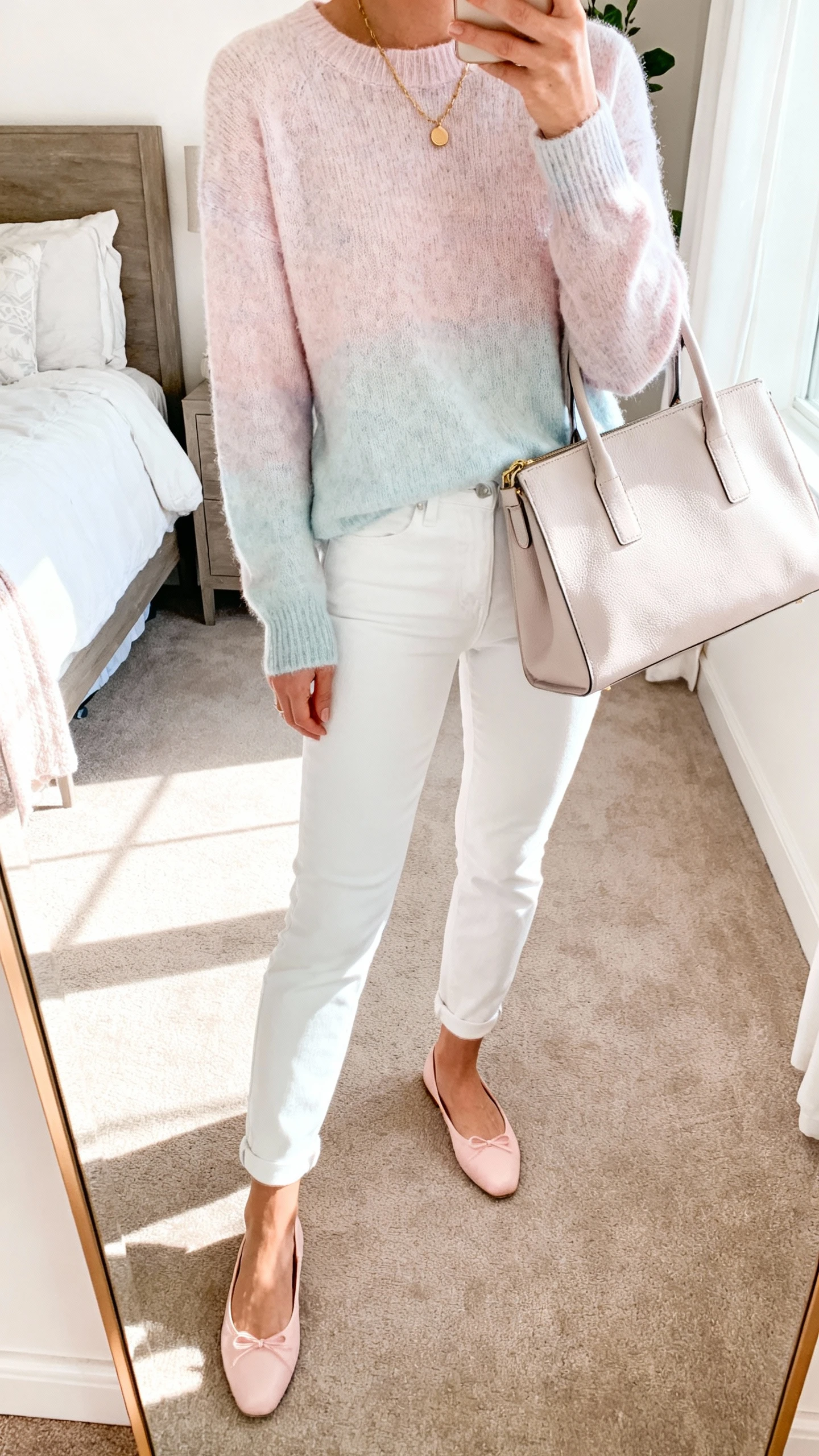 iPhone mirror selfie of a woman in white jeans paired with a soft pastel sweater, pastel ballet flats, light leather tote, subtle gold necklace, face not visible, cropped at neck, bedroom mirror, bright morning light, iPhone photo quality.