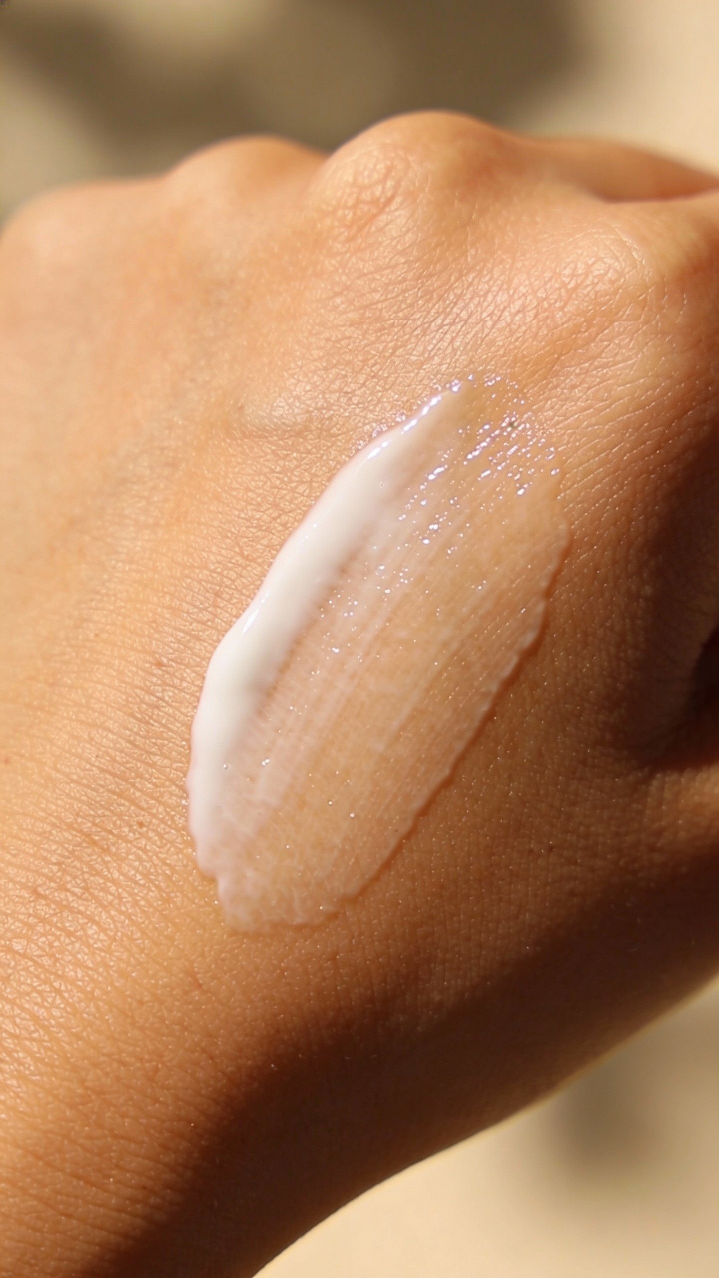 sunscreen smear on back of hand in soft daylight