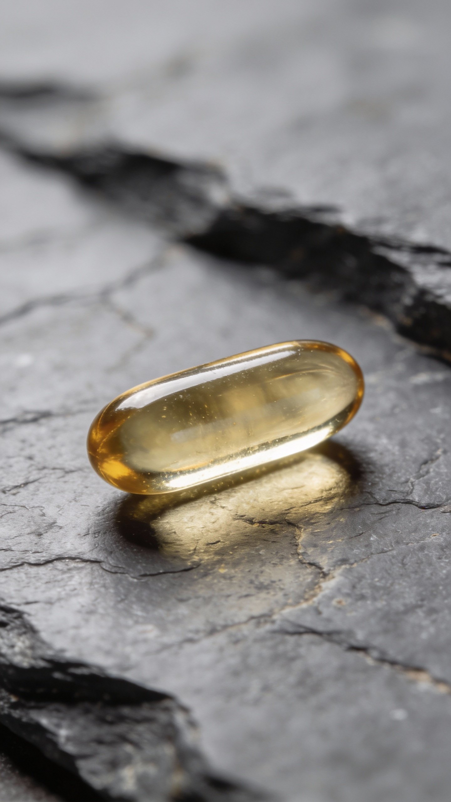 macro shot of one omega-3 fish oil capsule on slate