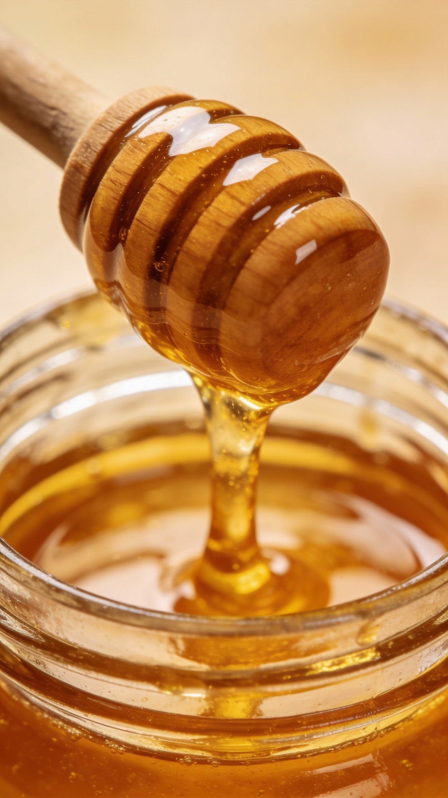 single honey jar with wooden dipper, macro on golden drip