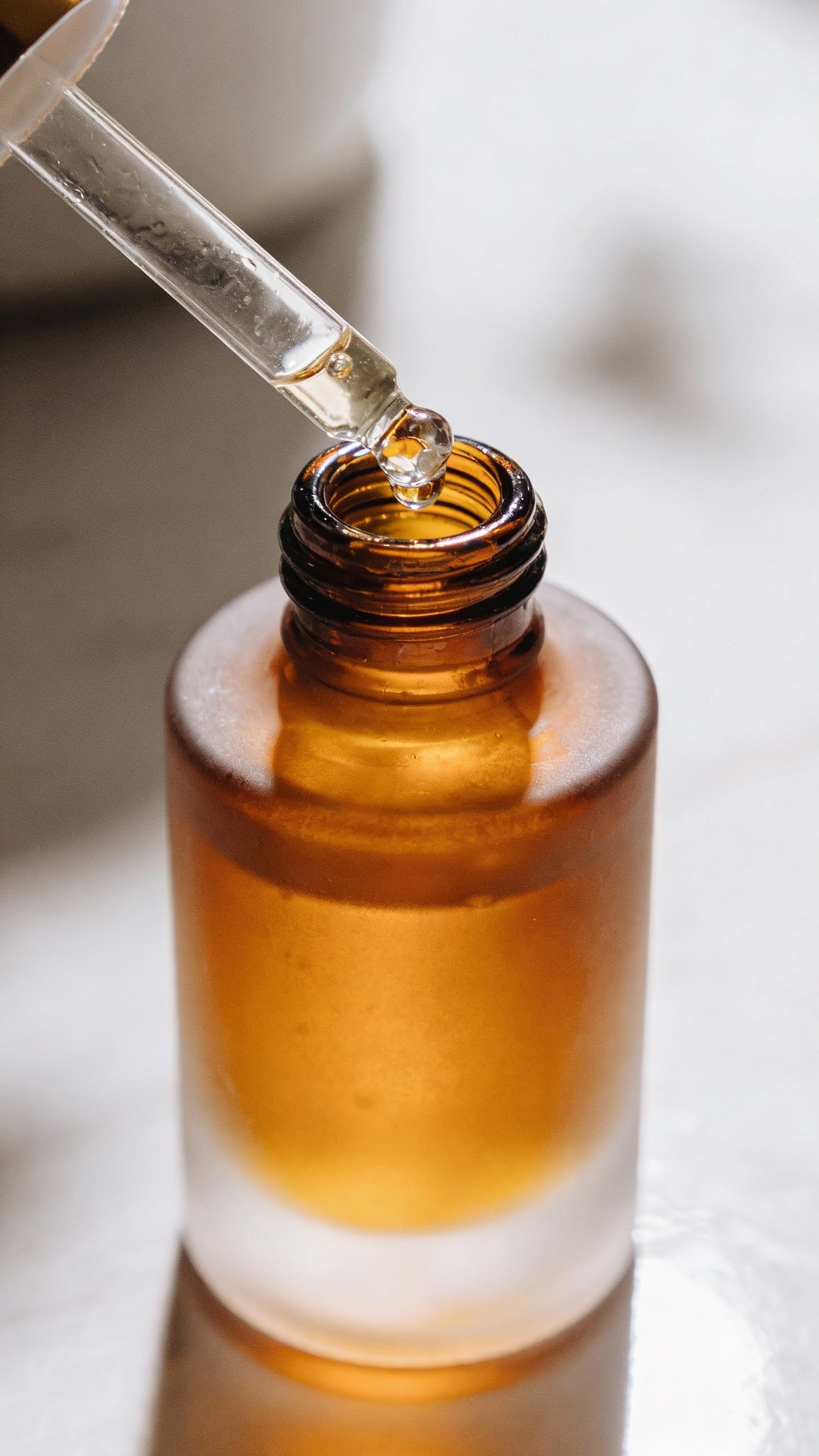 Frosted amber dropper bottle labeled “Water-Based Toner” closeup