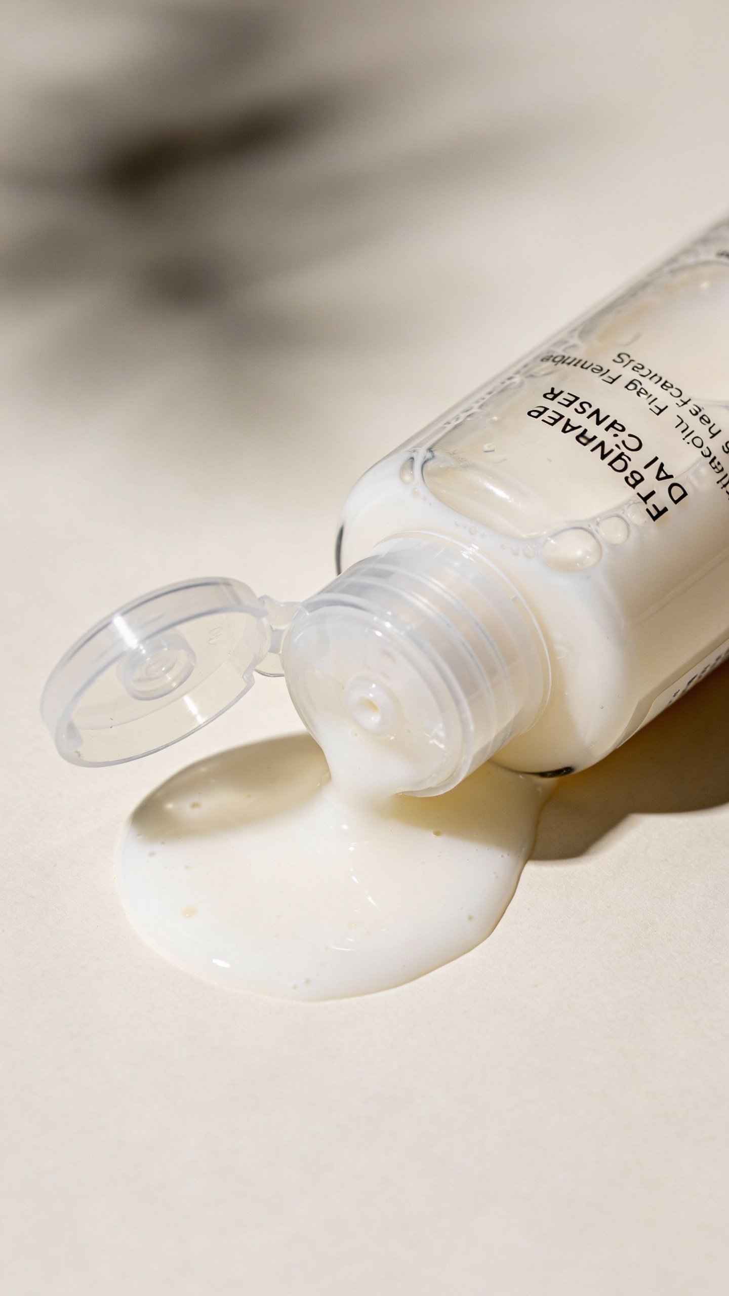 closeup of fragrance-free oat milk cleanser in clear pump bottle