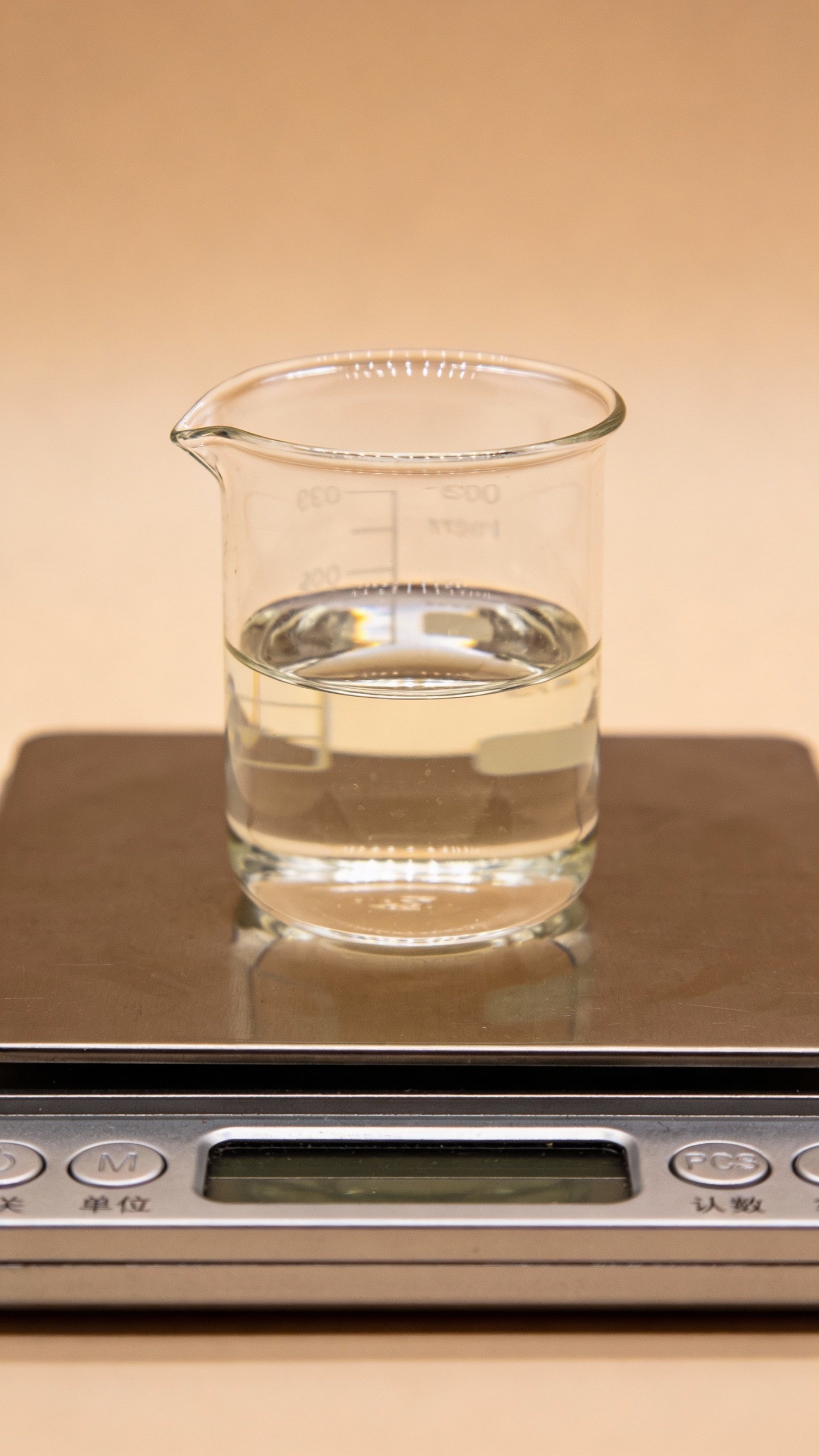 Stainless kitchen scale with single glass beaker of glycerin