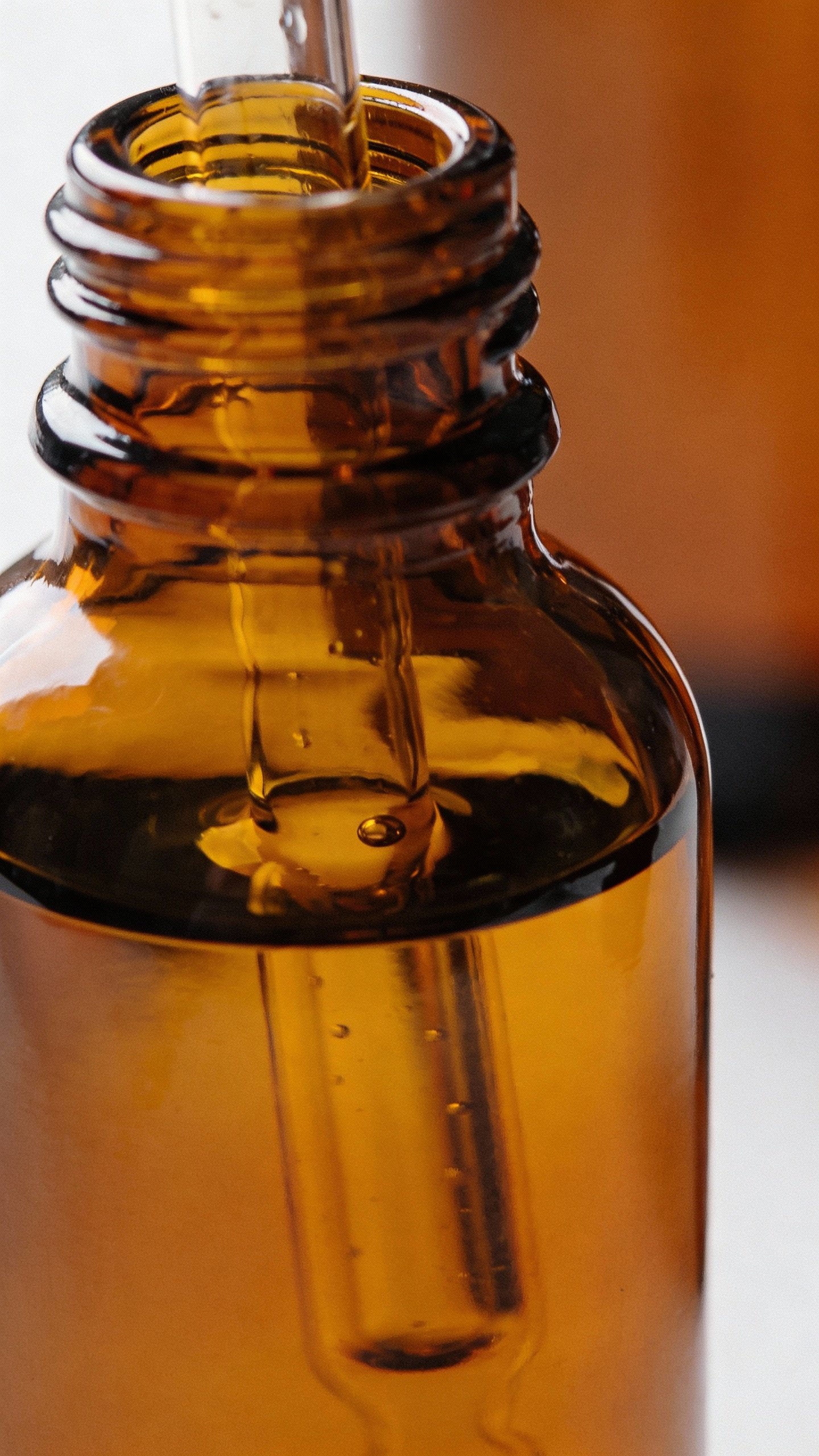 closeup amber dropper bottle labeled “15% LAA serum”