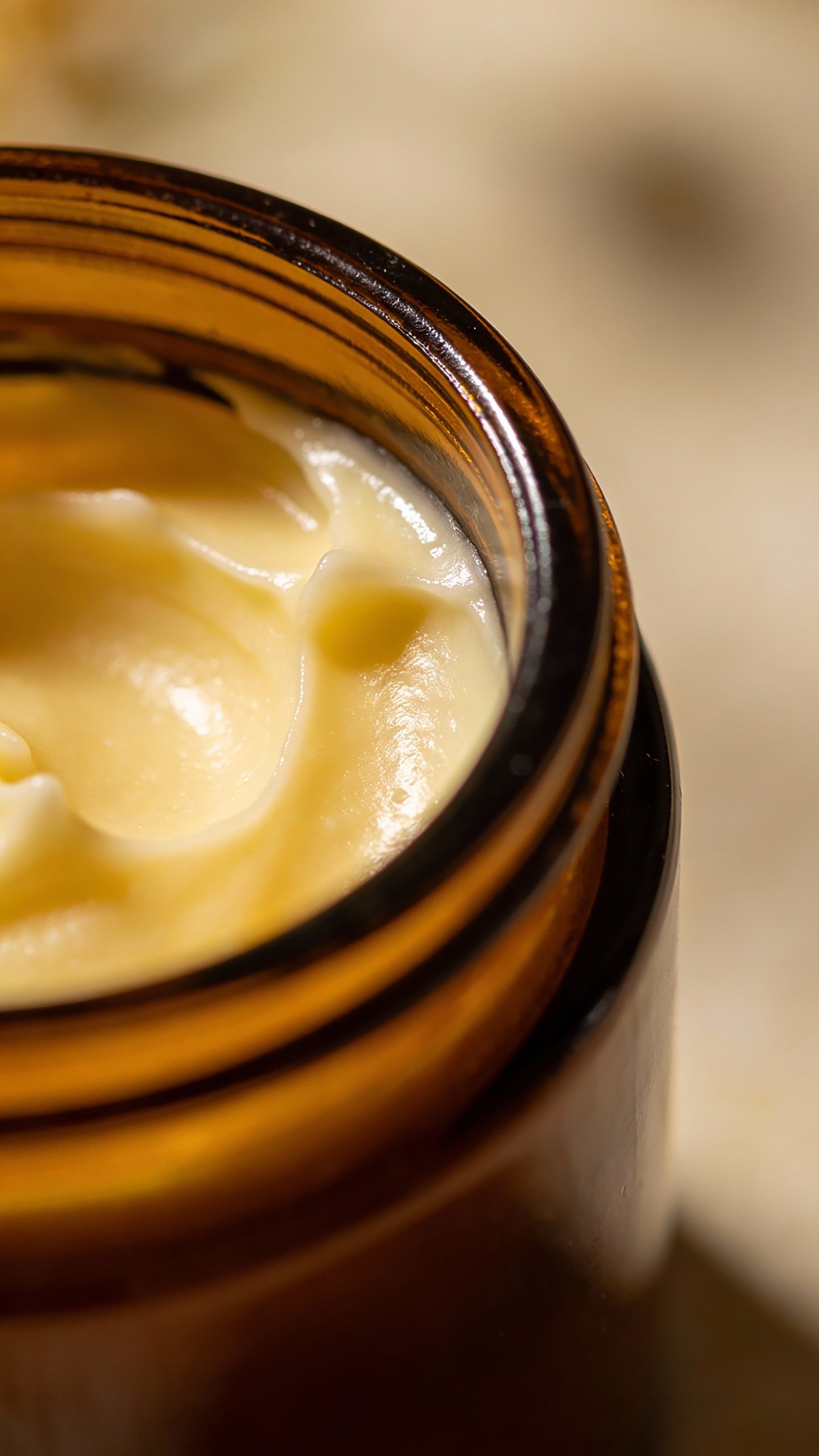 closeup of homemade night cream in amber glass jar