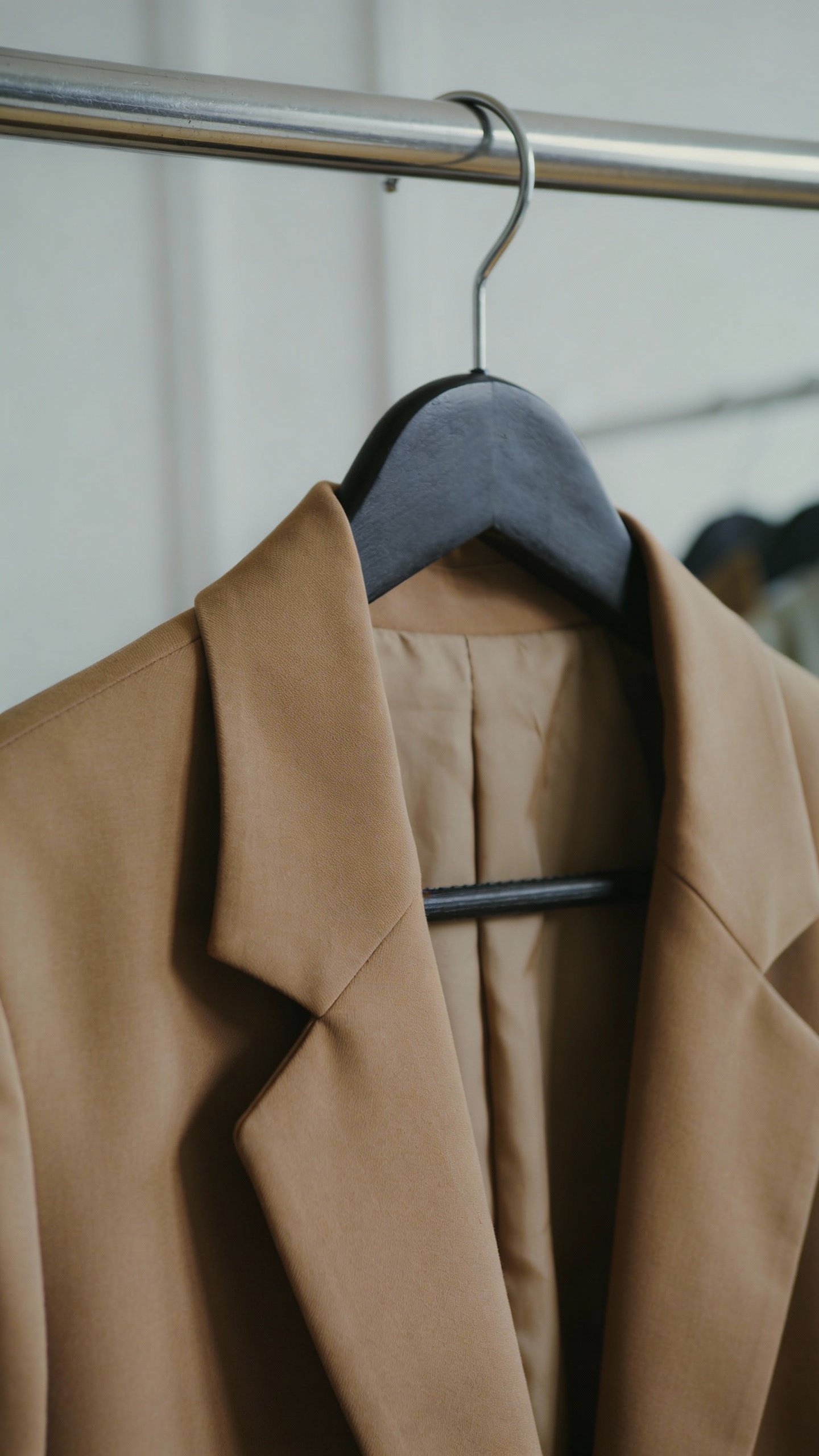 camel structured blazer on black hanger, closeup