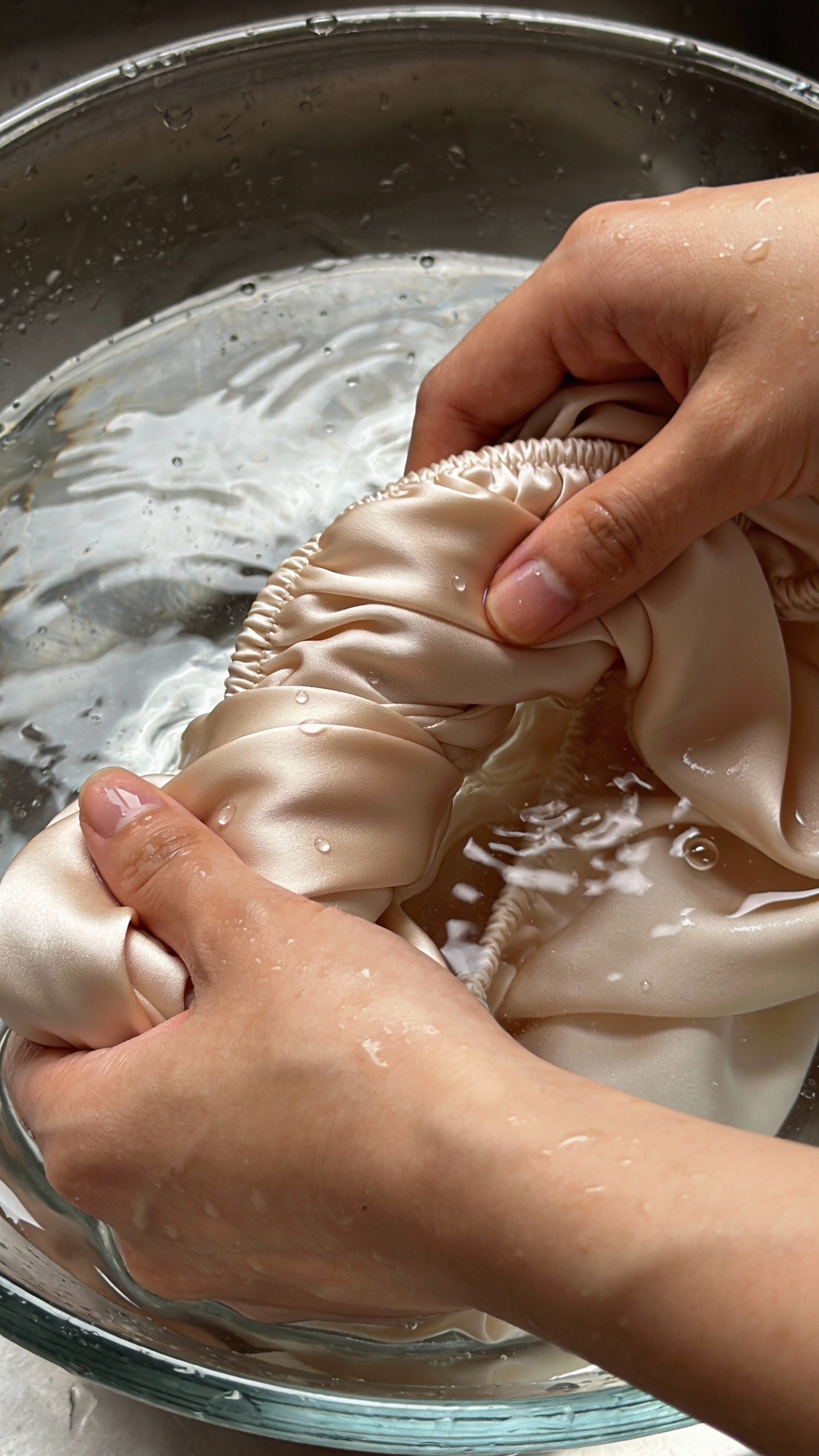 macro of silk blouse handwashing in clear basin