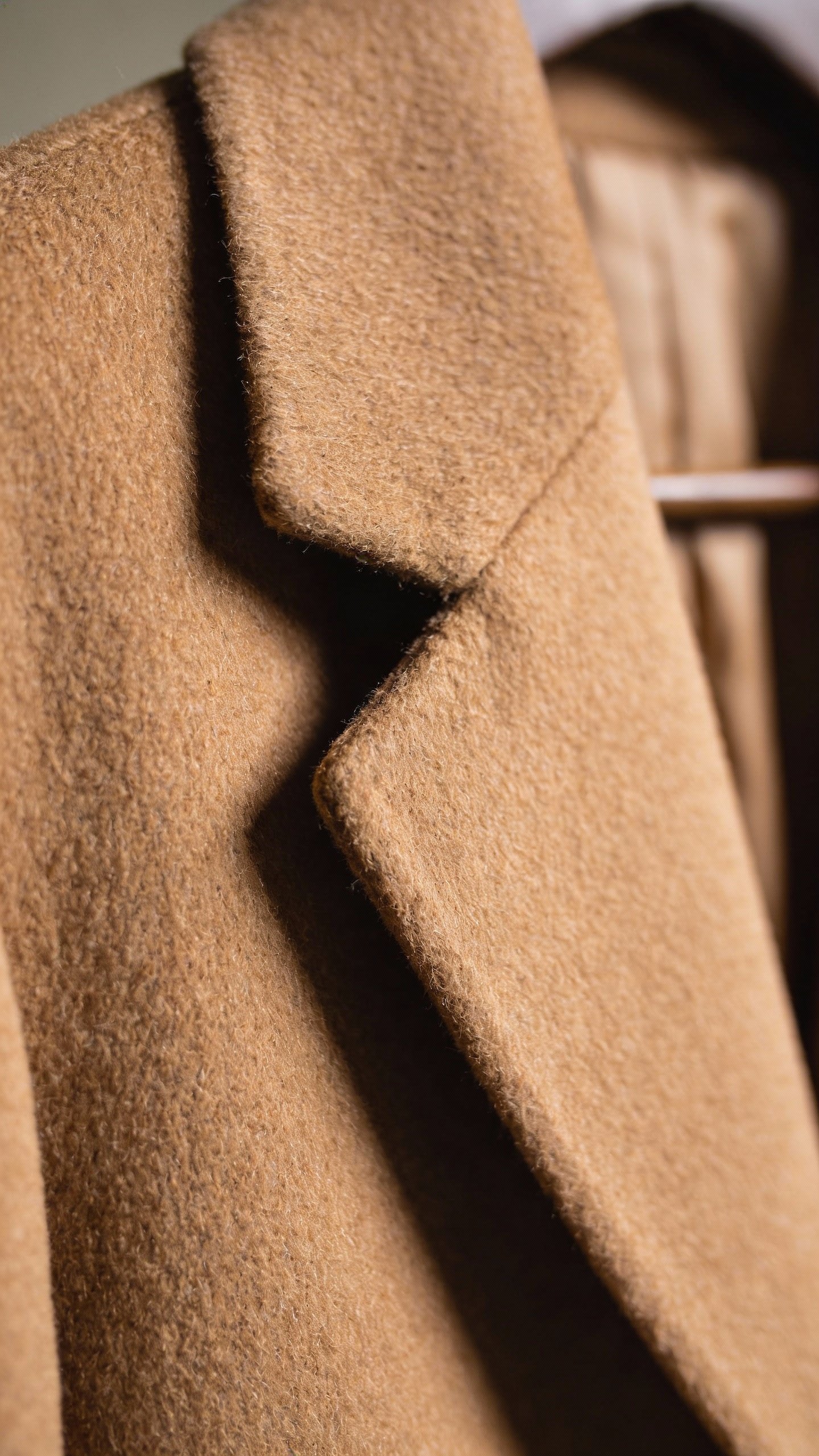 camel wool blazer lapel, closeup, soft studio lighting