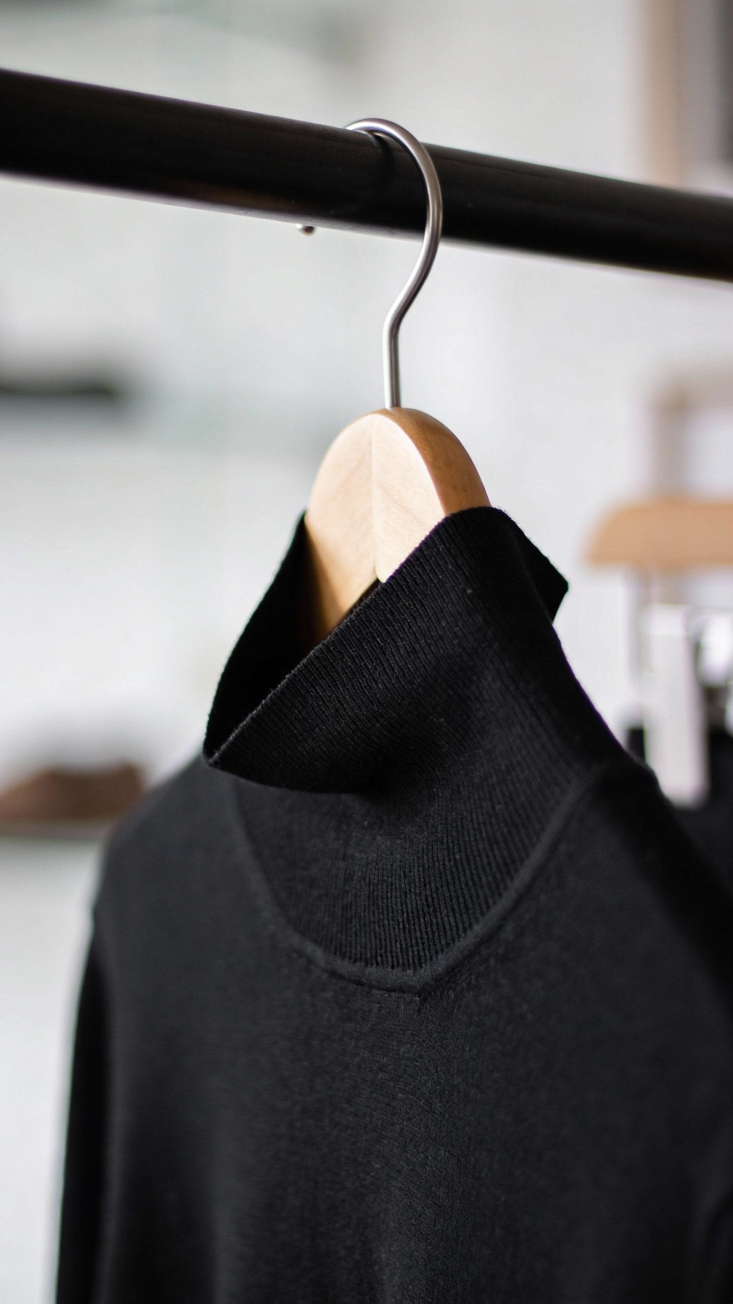 closeup black merino turtleneck base layer on hanger