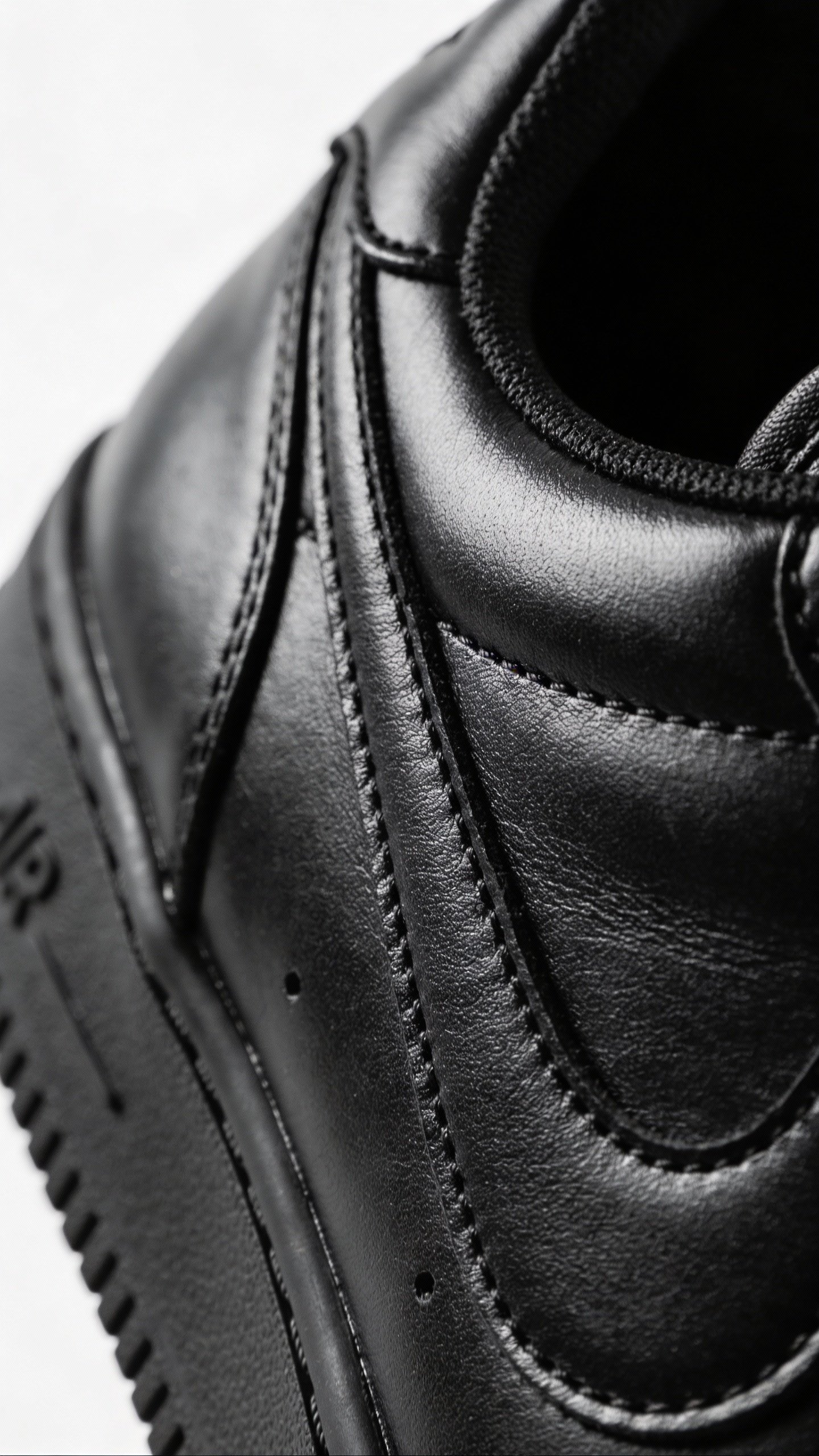 closeup of black leather sneaker on white background