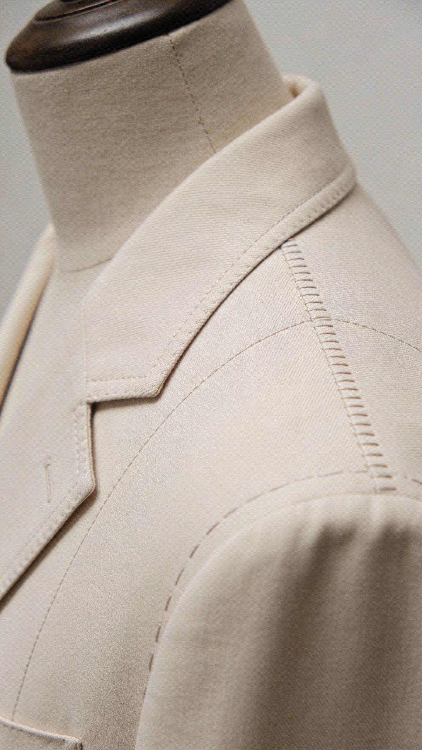 closeup of jacket shoulder seam alignment on tailor’s mannequin